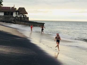 Mikhail Pimenov Running On Beach With His 2 Daughters Behind Him