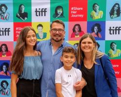 John Vellinga With His Wife Katherine And Children In Front Of Tiff Poster