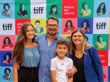 John Vellinga With His Wife Katherine And Children In Front Of Tiff Poster