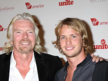 Richard Branson Smiling For Photo With Arm Around His Son