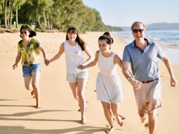 Steven Fisher Running On Beach With His Wife And Children