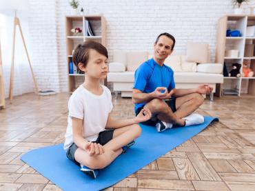 Father And Son Performing Yoga Together