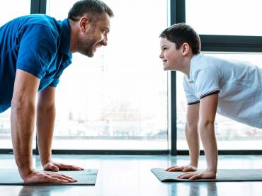 Grown Man And Teenage Boy Doing Push-Ups