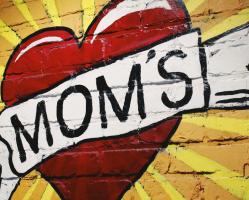 Heart With Word MOMs Across Heart Painted On Brick Wall