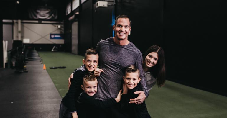 Jason Batt Smiling And Hugging His Children