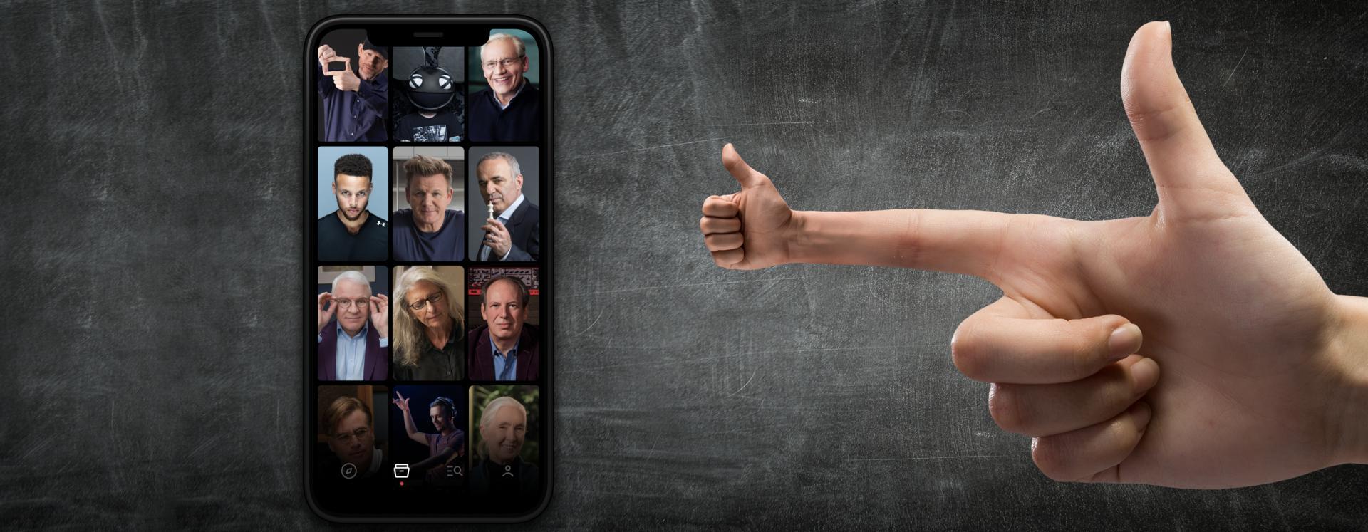Hand Making Thumbs Ups To Mobile Phone With Famous People Photos On Phone Screen