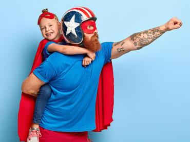 powerful-dad-in-protective-helmet-with-child-holding-on-his-back