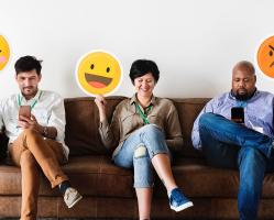 diverse-adult-people-sitting-and-holding-emojis-signs