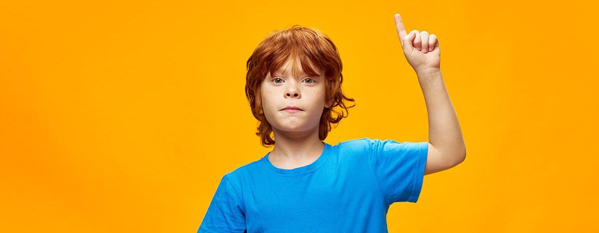 redhead-boy-in-blue-t-shirt-shows-thumb-up