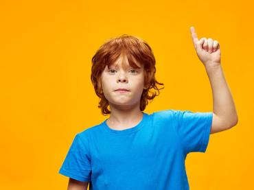 redhead-boy-in-blue-t-shirt-shows-thumb-up