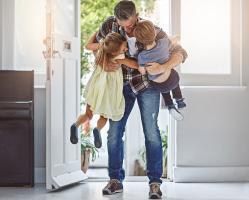 father-hugging-kids-in-house-doorway