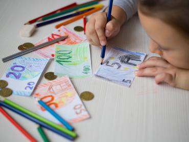 little-girl-draws-money-banknotes-with-colored-pen