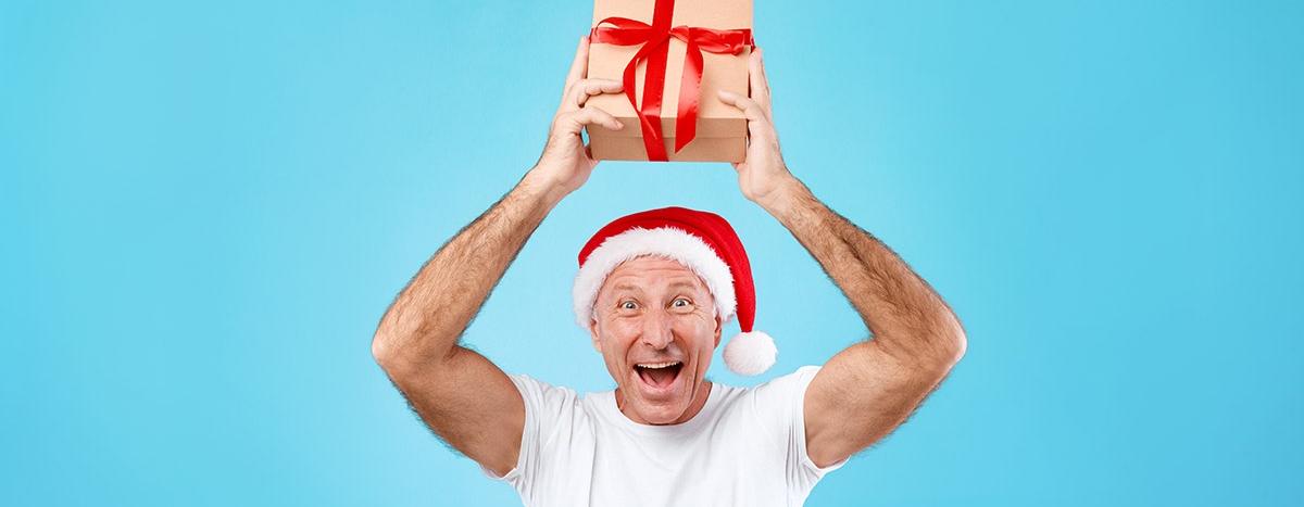 mature-man-holding-and-showing-christmas-present