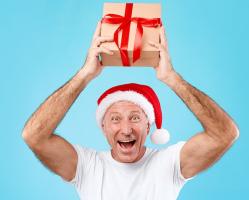 mature-man-holding-and-showing-christmas-present