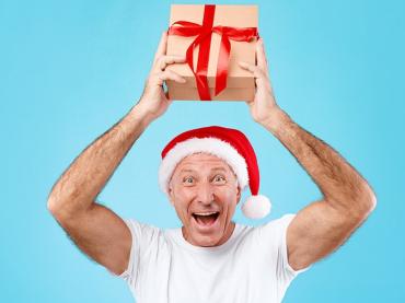 mature-man-holding-and-showing-christmas-present