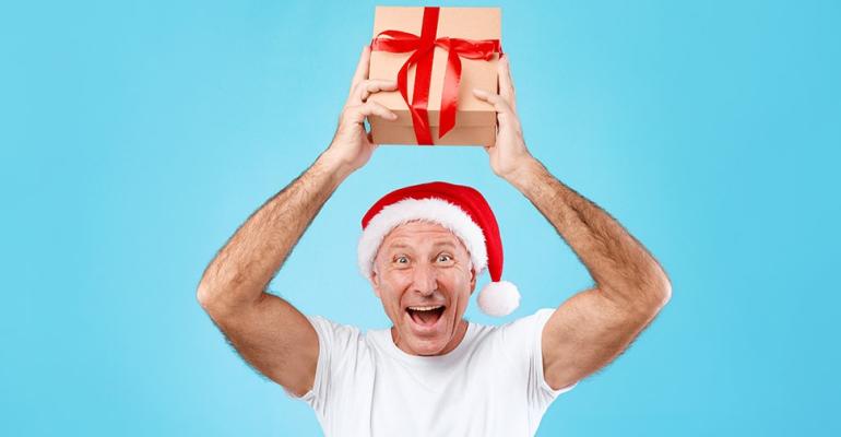 mature-man-holding-and-showing-christmas-present