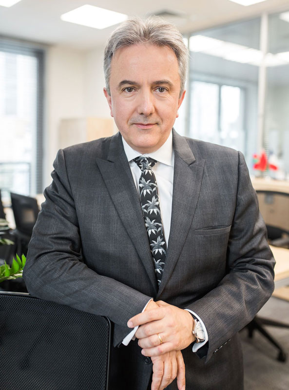 Francis Malige Of EBRD Posing For Photograph In Office Wearing A Business Suit