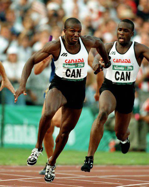 Bruny Surin Passing 4 x 400 Meter Team Race Batton To Donovan Baily At 1988 Olympics In Atlanta