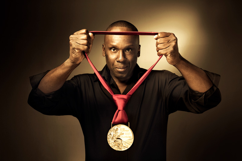 Bruny Surin holding Olympic Gold Medal