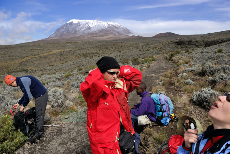 Backpackers Relaxing with Mount Kilimanjaro In Background