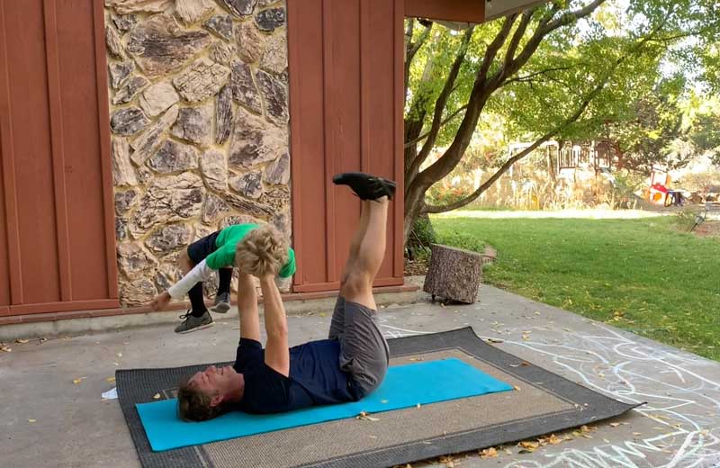 Sorren Harrison Of Fit Daddy 365 Doing 5 Lying Leg Lifts With Son