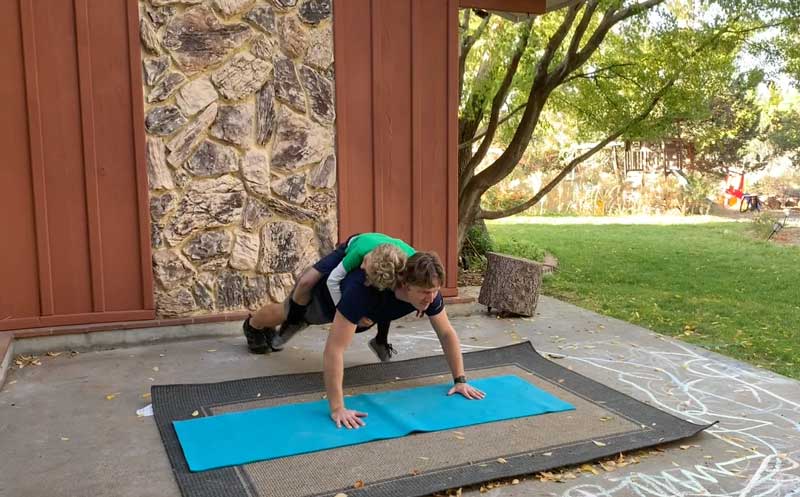 Sorren Harrison of Fit Daddy 365 Doing 5 Push-Ups With Son On His Back