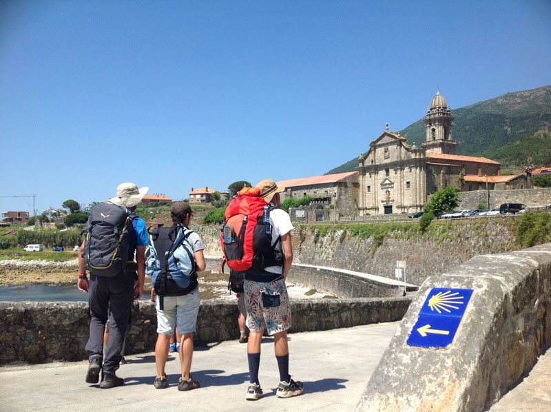 Walking Mentorship Program Backpackers Looking at Church 