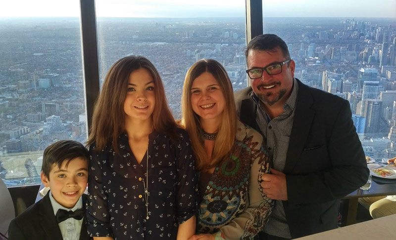 John Vellinga And His Family Posing For Photograph Overlooking City Of Toronto Canada From CN Tower