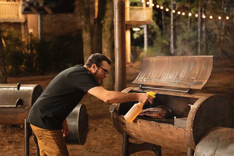 Cheff Aaron Franklin Cooking Meat In A BBQ