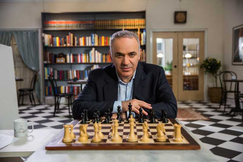 Chess Master Gary Kasparov Sitting In front of Chess Board