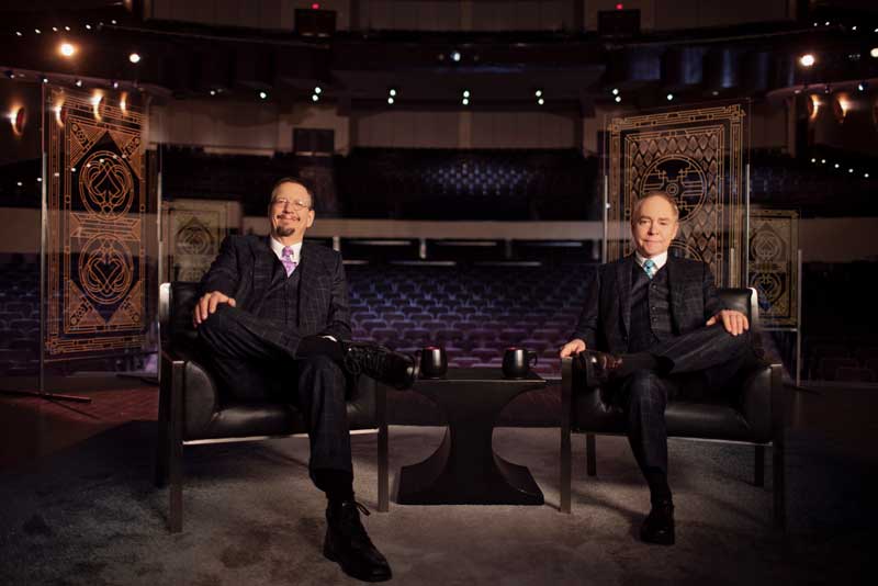 Penn And Teller Sitting On Chairs In Empty Theatre