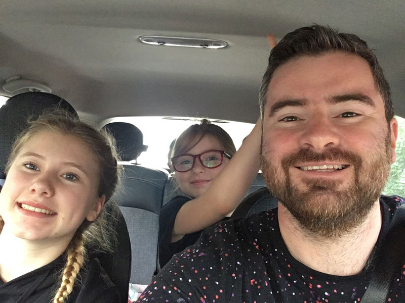 Mikhail Pimenov Smiling In Car With Daughter Alisa And Zoya