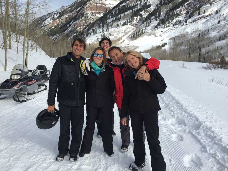 Oscar Munoz And Family With Winter Mountains And Snowmobiles