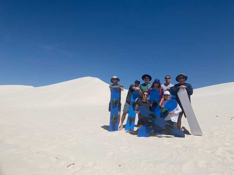 Oscar Munoz And His Family Posing For Photo With Snowboard In Desert 