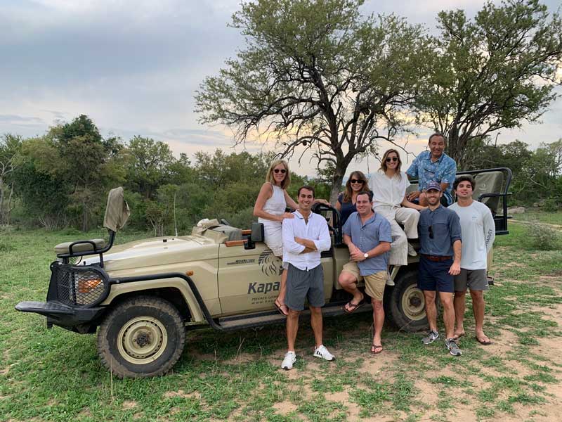 Oscar Munoz And His Family Posing In Front Of 4x4 On Safari In South Africa