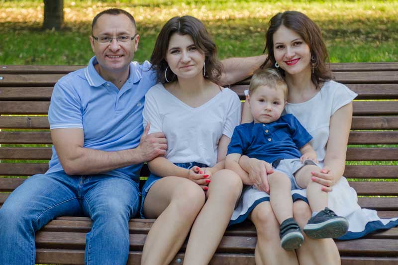Vasyl Myroshnychenko With Family Sitting On Park Bench