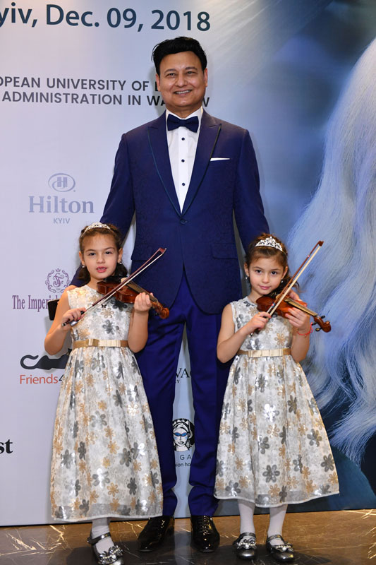 Mohammad Zahoor In Tuxedo With His Twin Daughters Each Holding A Violin